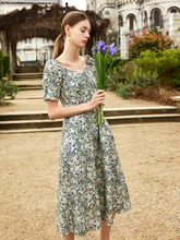a lady in a floral printed square neck midi dress